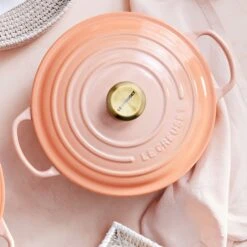 Le Creuset Signature Cast Iron 7.25-quart Peche Round Dutch Oven -Zwilling Shop 04 Peche Moodboard Overhead 0257 SQ HERO